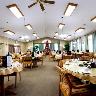 A spacious dining room with neatly arranged tables and elegant lighting.