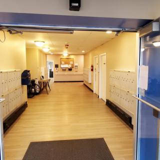 A building lobby with mailboxes and a reception area.