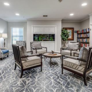 A modern living room with comfortable seating, a bookshelf, and tasteful decor.