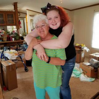 A joyful moment shared between two women in a cozy living room.