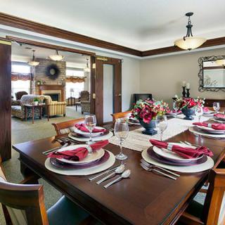 A beautifully set dining room table with elegant decor and ambient lighting.