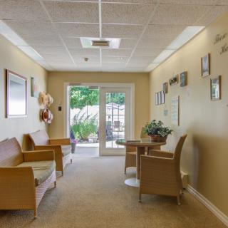 A cozy waiting room with comfortable seating and decor.