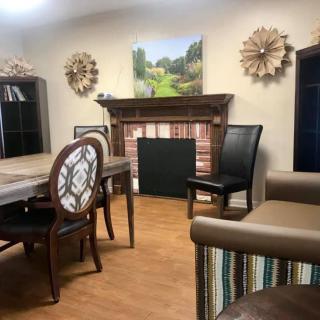 A cozy living room with elegant furniture and wall decor.