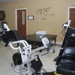A room equipped with exercise machines for fitness and rehabilitation.