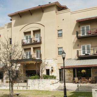 A residential building with balconies and outdoor seating area.