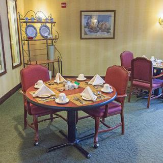 A neatly set dining table in a restaurant with elegant decor.