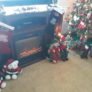 A cozy Christmas scene featuring a decorated tree, a warm fireplace, and festive ornaments.