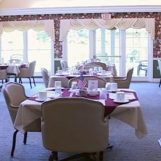 An elegantly set dining room with neatly arranged tables and chairs.