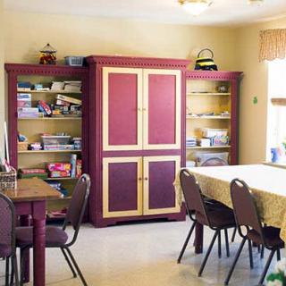 A well-organized study room with bookshelves, tables, and chairs.