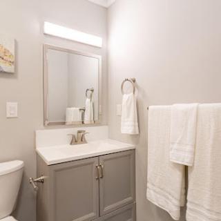 A modern bathroom featuring a stylish vanity and fresh towels.