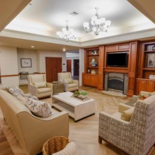 A cozy living room with comfortable seating, a fireplace, and a television.