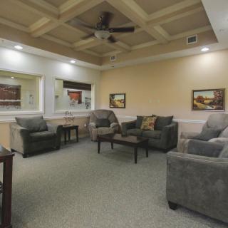 A cozy living room with comfortable seating and decorative artwork.