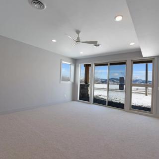 A spacious and modern living room with large windows providing abundant natural light.
