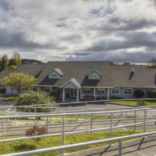 A suburban building with a ramp and cloudy sky.