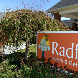 Sign for Radford Health & Rehabilitation Center surrounded by greenery.