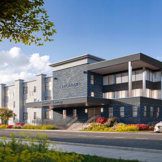 A modern hotel building with a sleek architectural design under a clear blue sky.