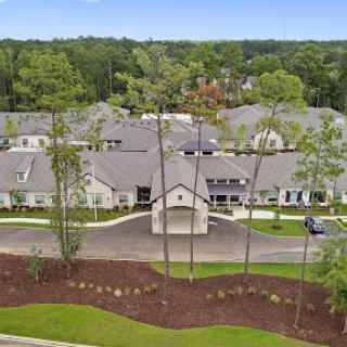 Aerial view of a modern residential community surrounded by lush greenery.