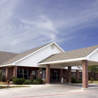 A commercial building with a covered entrance and clear blue skies.