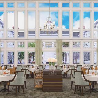 An elegant restaurant dining room with large windows and chandeliers.
