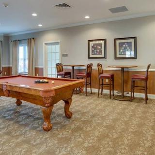 A cozy game room featuring a billiards table and seating area.