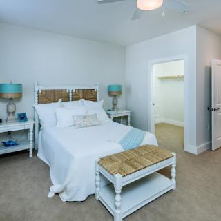 A cozy, modern bedroom featuring a stylish bed, matching lamps, and ample space.