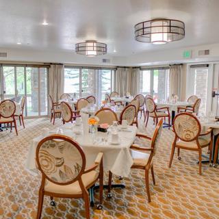 An elegant dining room with well-arranged tables and chairs, featuring stylish interior design and ample natural light.