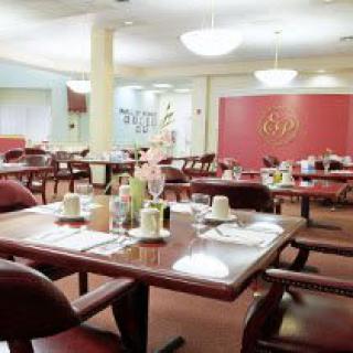 An elegant dining room with neatly arranged tables and chairs, ready for guests.