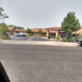 A view of a residential area with houses and parked cars.