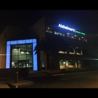 A modern office building illuminated at night.