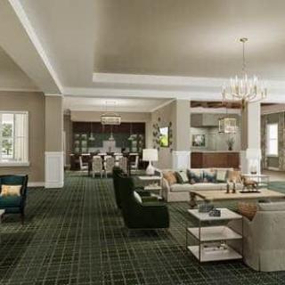 A spacious living room with elegant furniture and a chandelier.