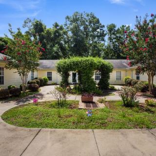A serene courtyard with lush greenery and a central path.