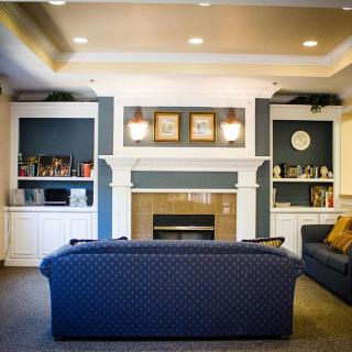 Cozy living room setup with a central fireplace and comfortable seating.