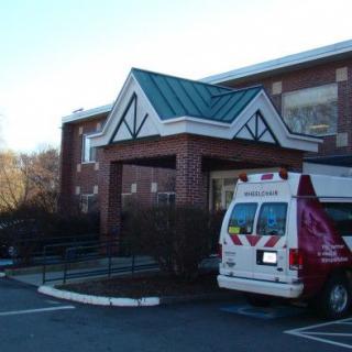 An ambulance parked near the entrance of a building.