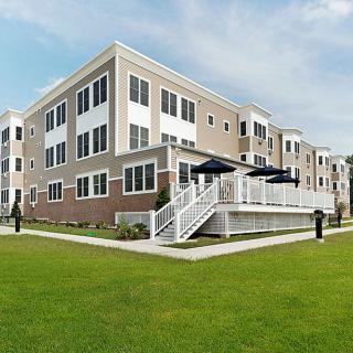 A modern residential apartment complex with well-maintained landscaping.