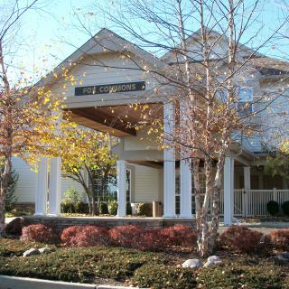 A building surrounded by trees and autumn landscaping.