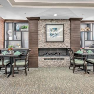 A modern dining area with a central fireplace and elegant decor.