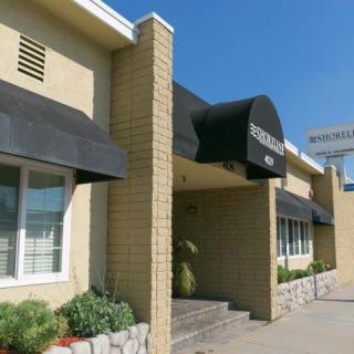 Entrance of a commercial building with awnings and signage.