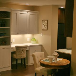 A cozy kitchen and dining area with elegant lighting and modern furniture.