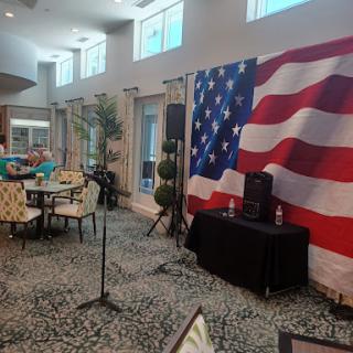 A cozy indoor venue featuring an American flag backdrop, ready for an event.