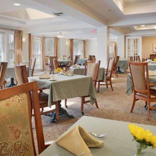 An elegantly designed dining room with neatly arranged tables and chairs in a formal setting.