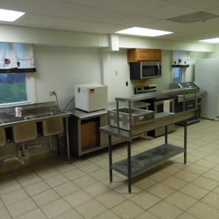 A clean and well-organized commercial kitchen with stainless steel appliances and ample counter space.