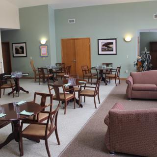 A cozy lounge area with tables, chairs, and sofas arranged for comfort.