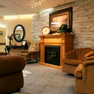 A cozy living room with a fireplace and comfortable seating.