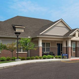 A suburban residential building with well-maintained landscaping.