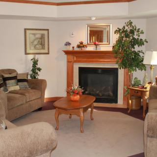 A cozy living room with a fireplace and comfortable seating arrangement.