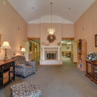A cozy living room interior with a fireplace and comfortable seating.