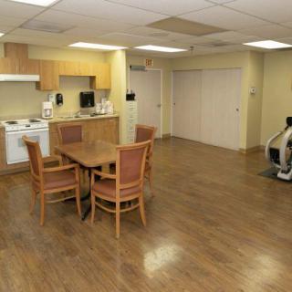 A spacious kitchen and dining area with wooden floors and modern appliances.