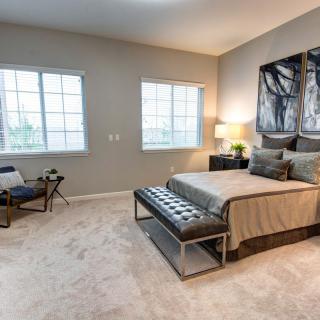 A modern bedroom with elegant furnishings and natural lighting.