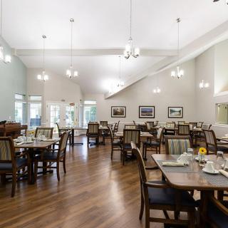 Spacious dining area with elegantly arranged tables and modern lighting.