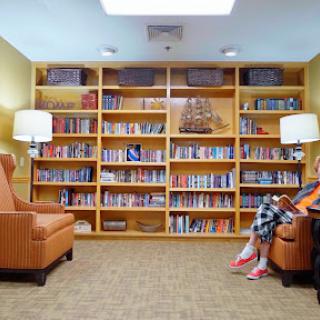A cozy reading nook featuring a well-stocked bookshelf and comfortable seating.